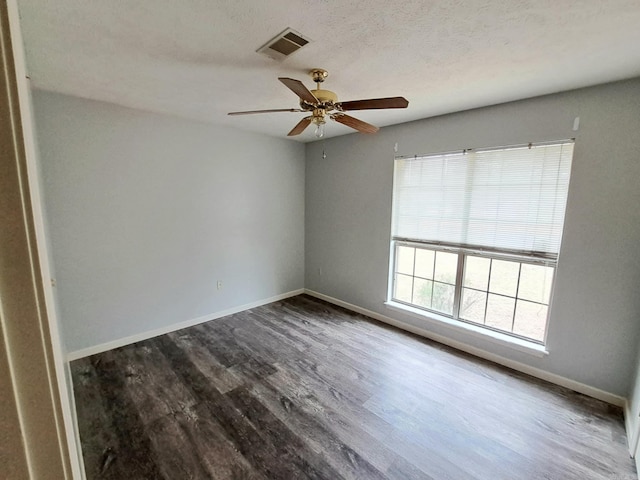 empty room featuring hardwood / wood-style flooring, ceiling fan, and a textured ceiling