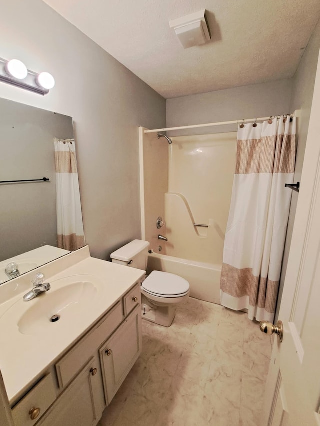 full bathroom with vanity, shower / tub combo with curtain, a textured ceiling, and toilet