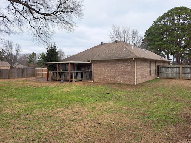 rear view of house with a yard