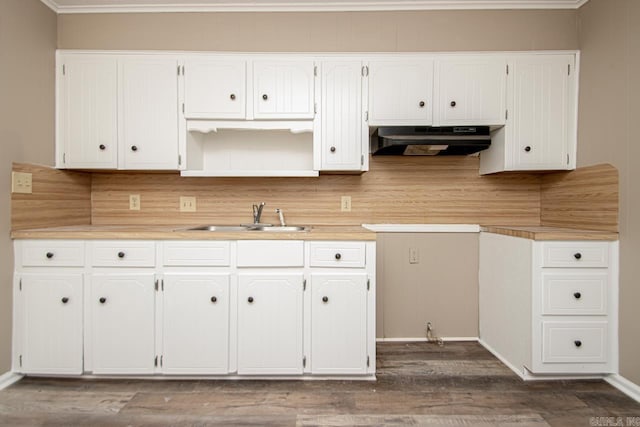 kitchen featuring backsplash, dark hardwood / wood-style floors, sink, and white cabinets