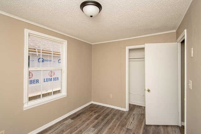 unfurnished bedroom with a closet, ornamental molding, dark hardwood / wood-style flooring, and a textured ceiling