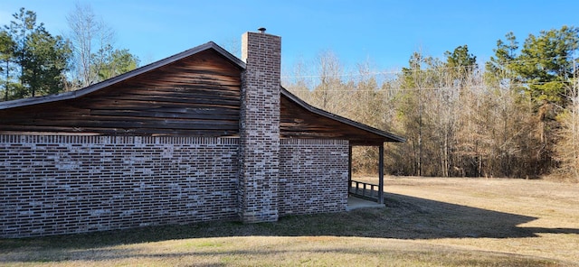 view of side of home with a lawn