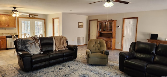 living room with ceiling fan and french doors