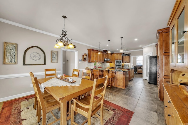 dining room featuring baseboards, ornamental molding, tile patterned flooring, and recessed lighting