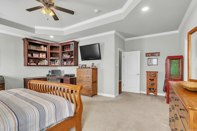 bedroom featuring light carpet, baseboards, a tray ceiling, and ornamental molding