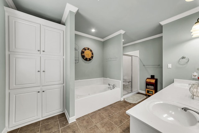 bathroom featuring a garden tub, crown molding, a sink, a shower stall, and tile patterned flooring