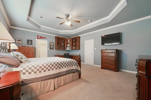 bedroom with a tray ceiling, light colored carpet, visible vents, ornamental molding, and baseboards