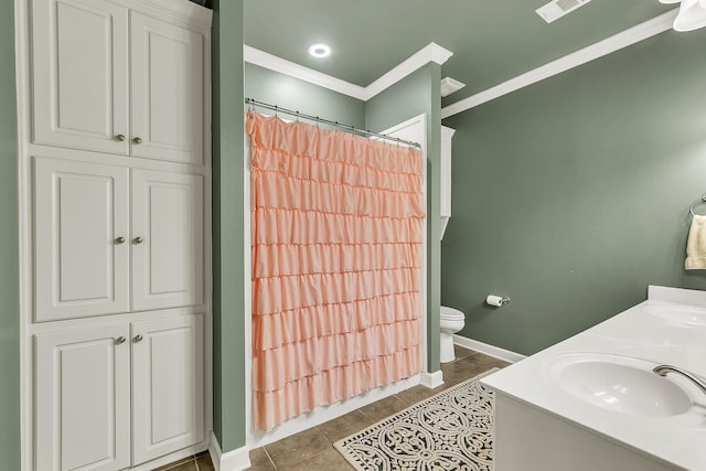 full bathroom with ornamental molding, a sink, toilet, and tile patterned floors