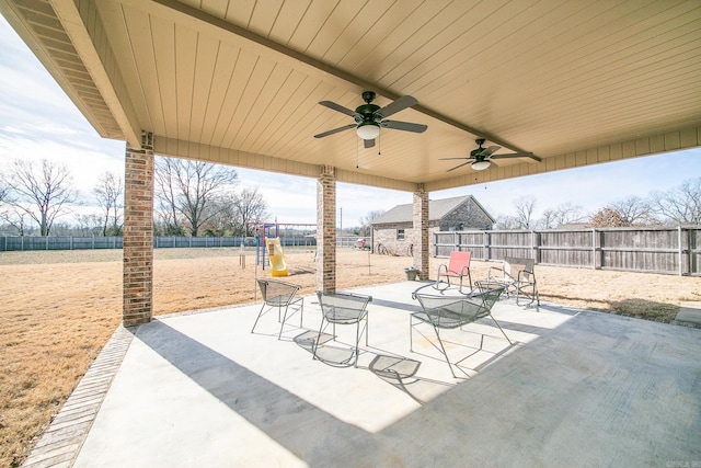 view of patio / terrace with ceiling fan and a playground