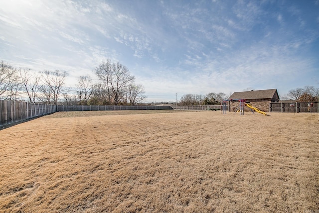 view of yard featuring a playground and a fenced backyard