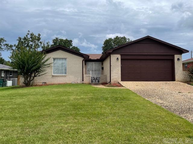 single story home with a garage and a front yard