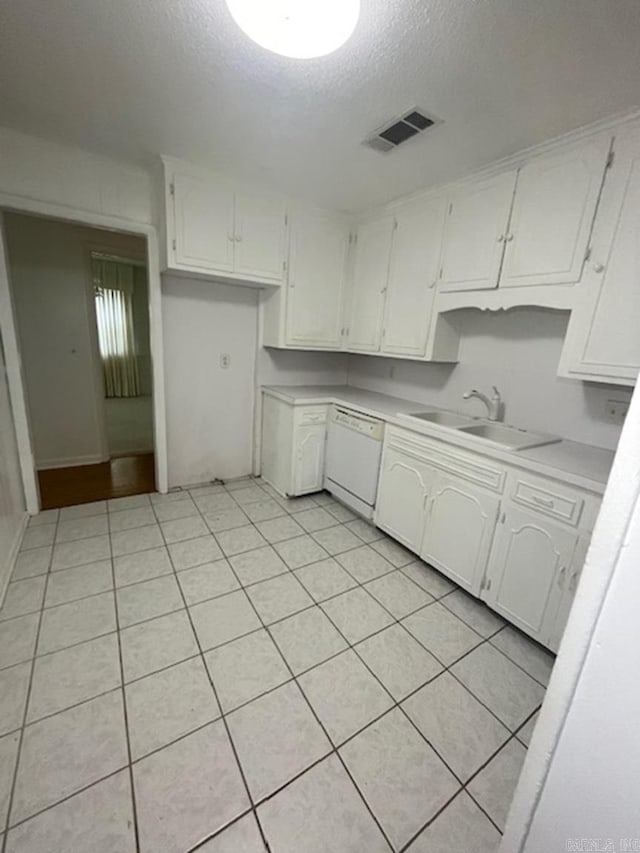 kitchen featuring sink, a textured ceiling, white cabinets, and white dishwasher