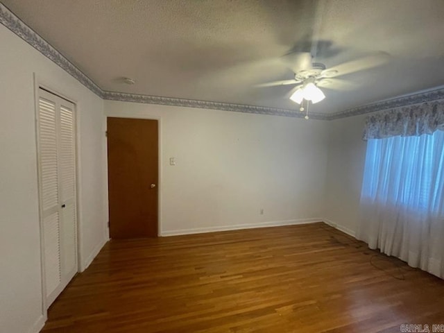 interior space with hardwood / wood-style flooring, ceiling fan, ornamental molding, and a textured ceiling