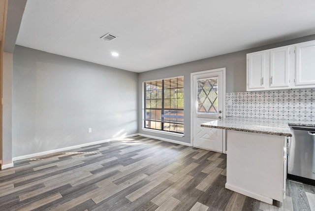 kitchen featuring tasteful backsplash, dark hardwood / wood-style flooring, dishwasher, and white cabinets