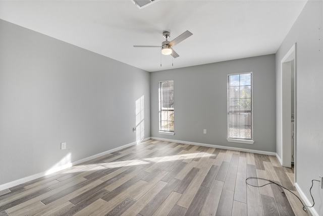 empty room featuring ceiling fan and light wood-type flooring