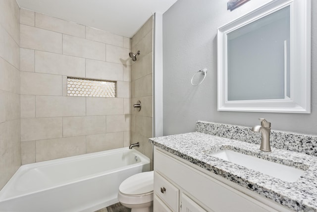 full bathroom with vanity, toilet, and tiled shower / bath combo