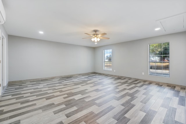 empty room featuring ceiling fan and light wood-type flooring