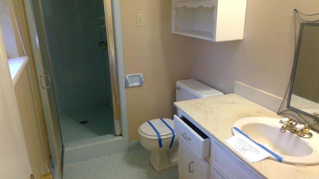 bathroom with vanity, toilet, tile patterned floors, and walk in shower