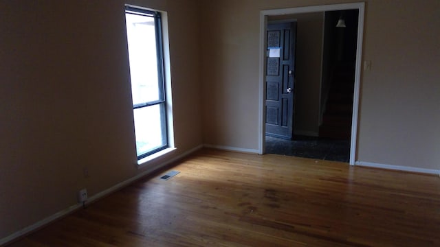 unfurnished room featuring wood-type flooring