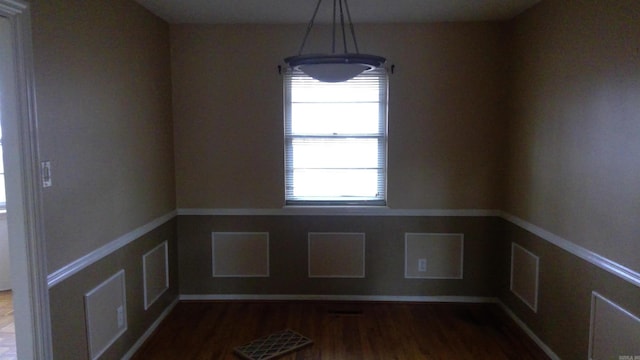 unfurnished dining area featuring hardwood / wood-style flooring