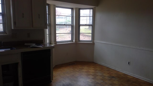 kitchen featuring sink, a wealth of natural light, and dark parquet floors