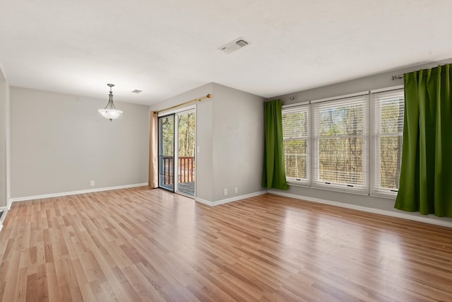 empty room with light hardwood / wood-style floors