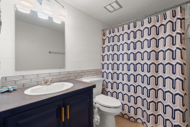 bathroom with vanity, a shower with curtain, tile walls, and toilet