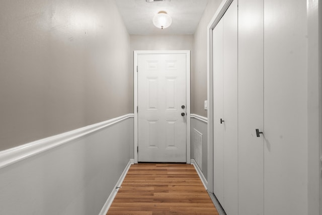 hall with wood-type flooring