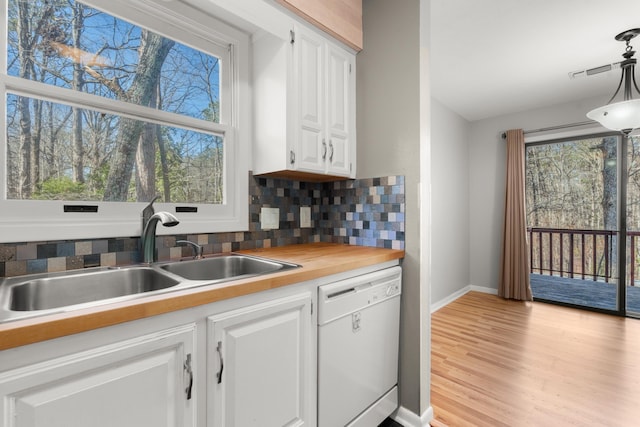 kitchen with sink, white cabinetry, tasteful backsplash, decorative light fixtures, and dishwasher