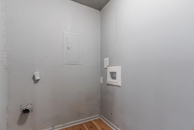 clothes washing area featuring washer hookup, hardwood / wood-style flooring, and electric panel