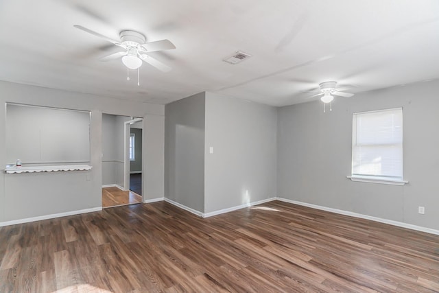 empty room with ceiling fan and dark hardwood / wood-style flooring