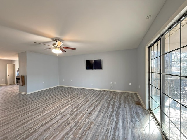 empty room with wood-type flooring and ceiling fan