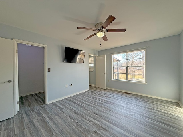 unfurnished bedroom featuring wood-type flooring and ceiling fan