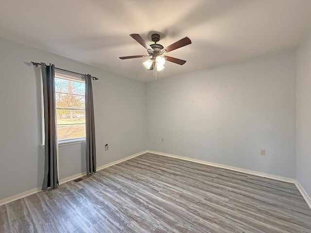 spare room with hardwood / wood-style flooring and ceiling fan