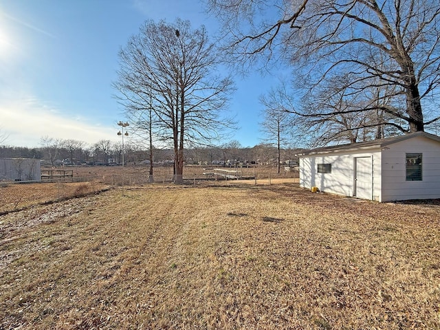 view of yard featuring an outdoor structure and a rural view