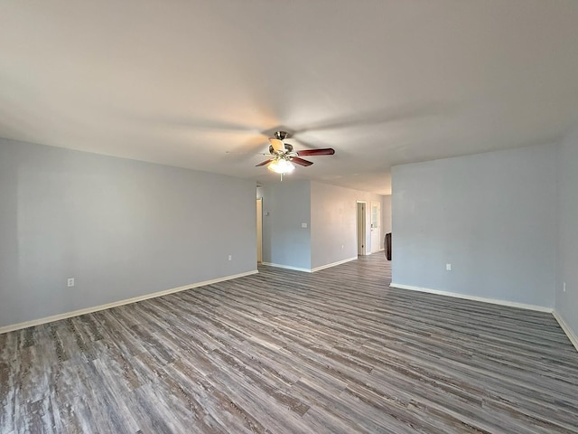 empty room featuring dark hardwood / wood-style floors and ceiling fan