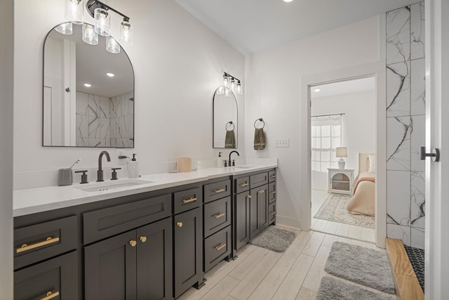 bathroom with vanity, hardwood / wood-style floors, and tiled shower