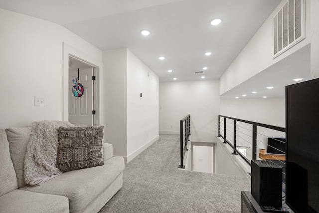 hallway with vaulted ceiling and carpet