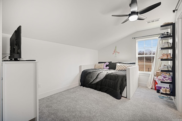 carpeted bedroom with ceiling fan and vaulted ceiling