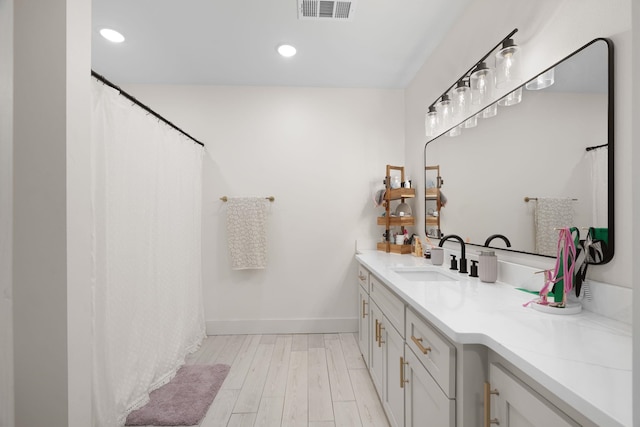 bathroom featuring hardwood / wood-style flooring and vanity