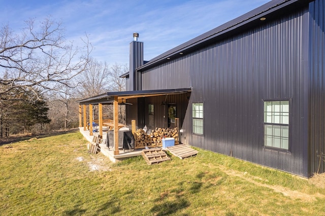 rear view of property with a yard