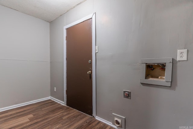 clothes washing area with electric dryer hookup, washer hookup, dark hardwood / wood-style flooring, and a textured ceiling