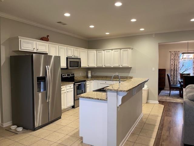 kitchen featuring sink, light stone counters, crown molding, stainless steel appliances, and white cabinets