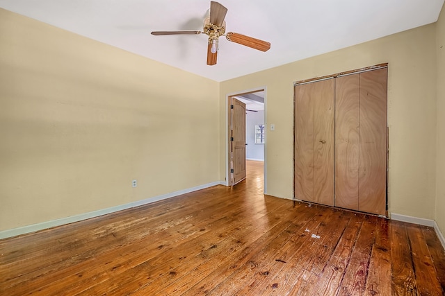 unfurnished bedroom with ceiling fan, dark hardwood / wood-style flooring, and a closet