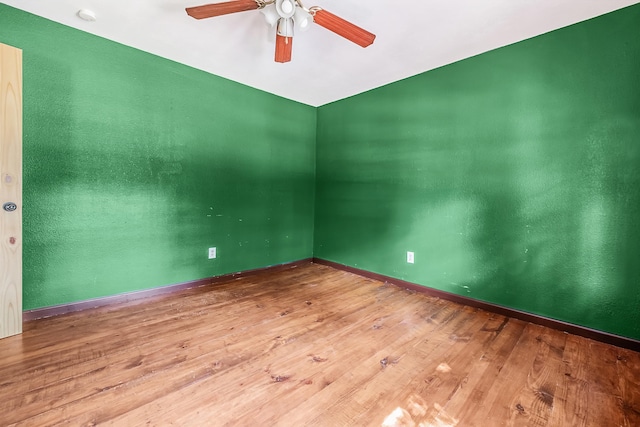 empty room featuring wood-type flooring and ceiling fan