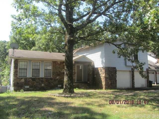 view of front of house with a garage and a front lawn