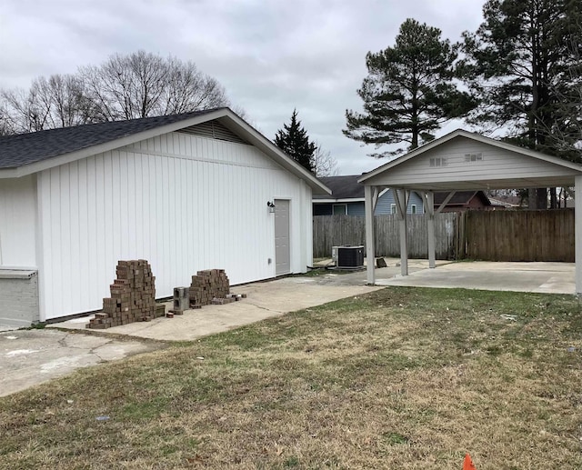 view of side of property with central AC, a patio, and a lawn