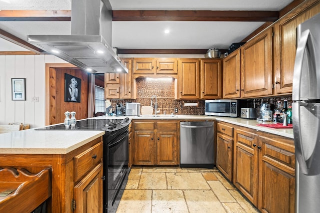 kitchen featuring appliances with stainless steel finishes, beamed ceiling, sink, island exhaust hood, and kitchen peninsula