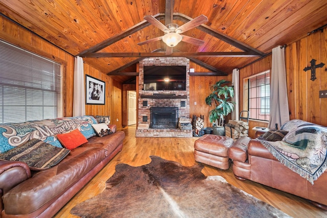 living room with wood ceiling, a fireplace, light hardwood / wood-style floors, and wood walls