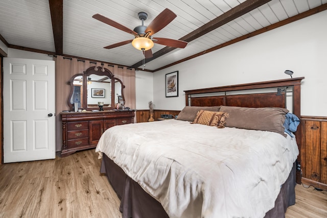 bedroom with beamed ceiling, ceiling fan, and light hardwood / wood-style flooring